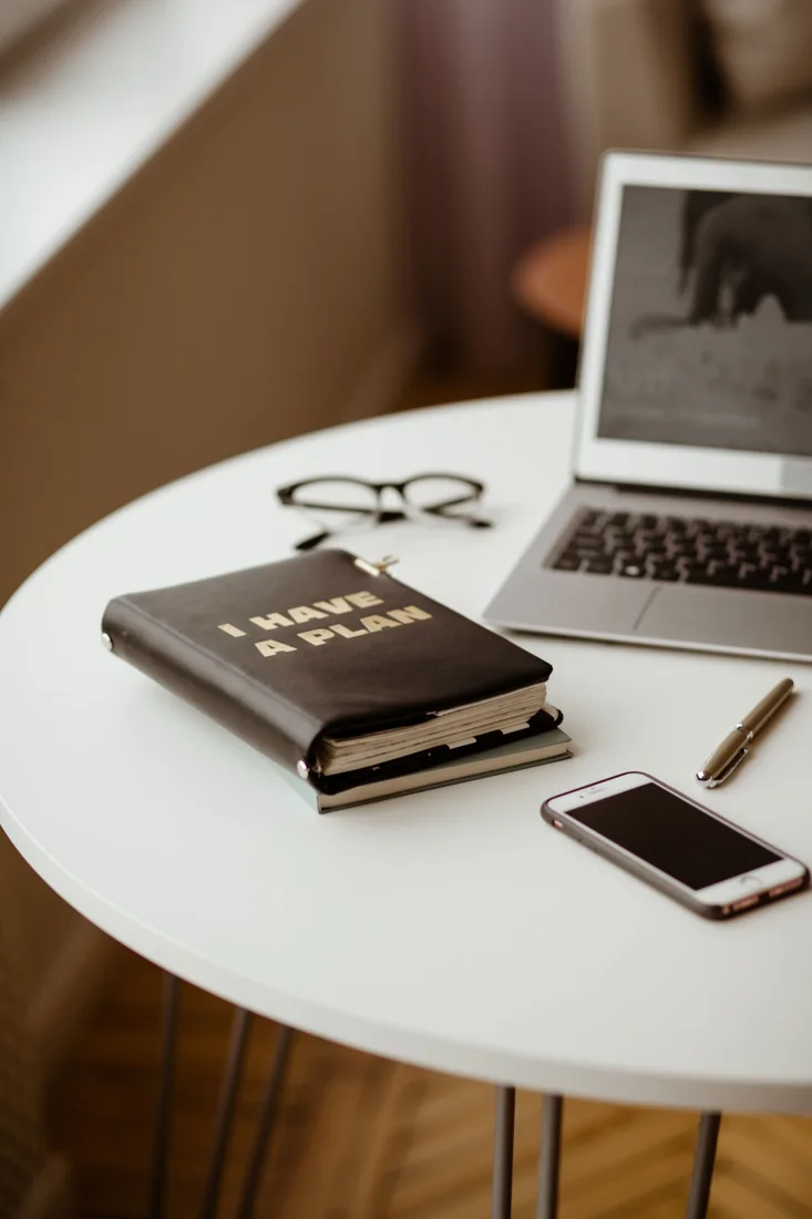 Laptop, planner and study materials on a desk